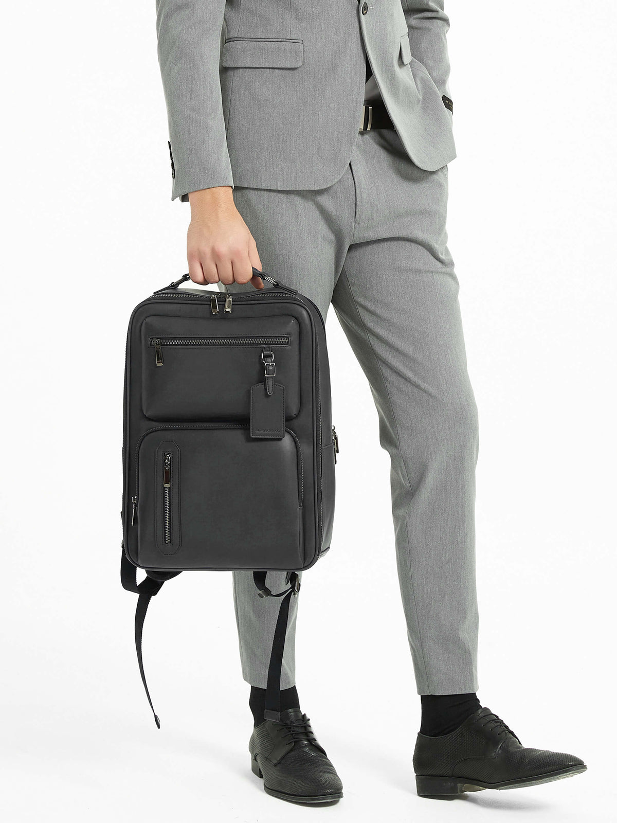 Aurean Paris - Explorer Light Backpack Plus Male model carrying Explorer Light Backpack Plus wearing formal business attire.