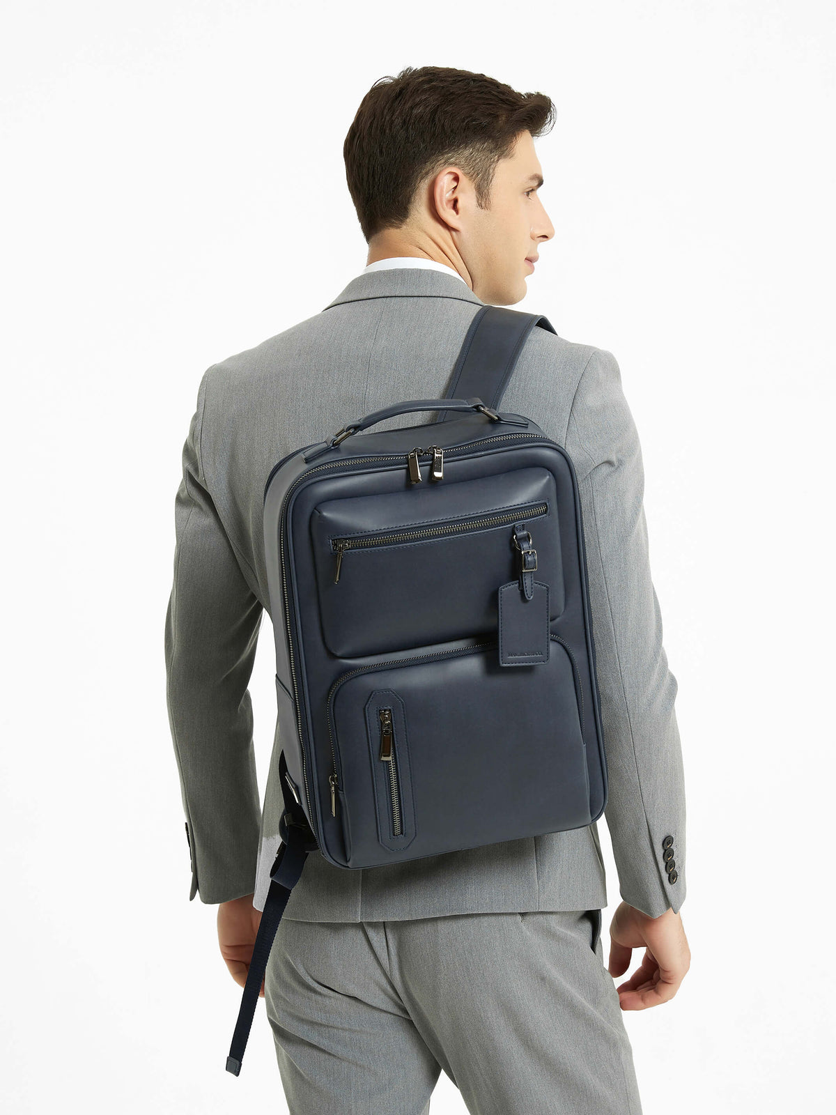 Aurean Paris - Explorer Light Backpack Plus Male model carrying Explorer Light Backpack Plus wearing formal business attire.